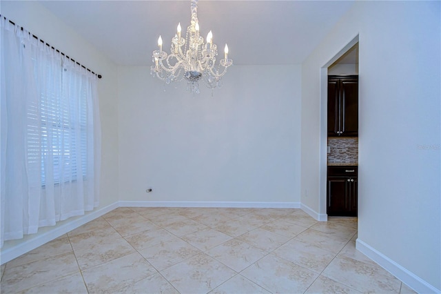 unfurnished dining area featuring a notable chandelier