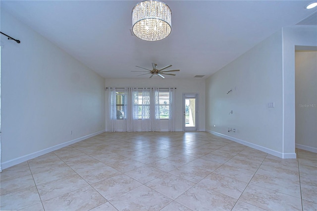 spare room with ceiling fan with notable chandelier and light tile patterned floors