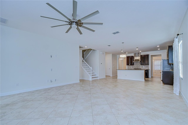 unfurnished living room featuring ceiling fan and light tile patterned floors