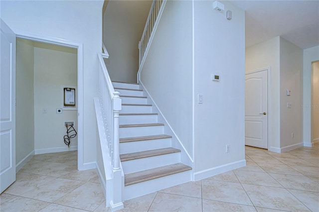 stairs featuring tile patterned flooring