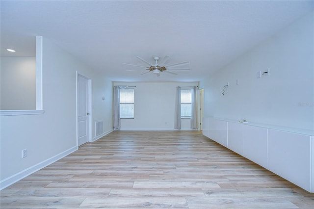 empty room featuring light hardwood / wood-style flooring and ceiling fan