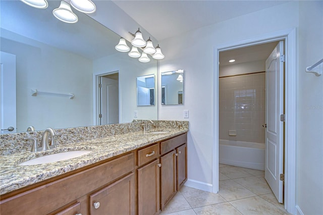 bathroom featuring a notable chandelier, tiled shower / bath combo, vanity, and tile patterned floors