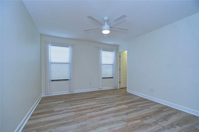 empty room featuring ceiling fan and light wood-type flooring