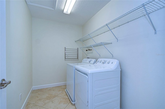 laundry room featuring light tile patterned floors and separate washer and dryer