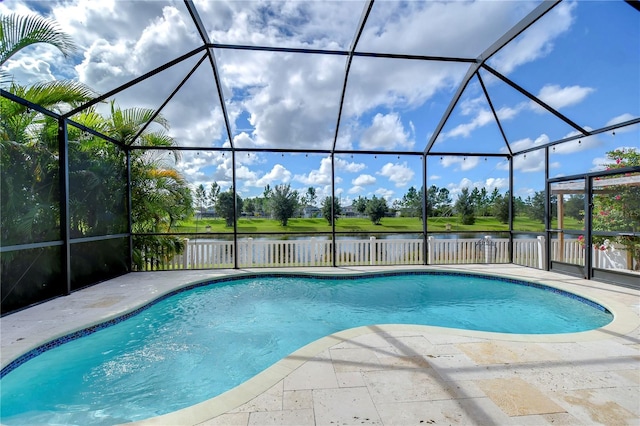 view of swimming pool with glass enclosure, a water view, and a patio area