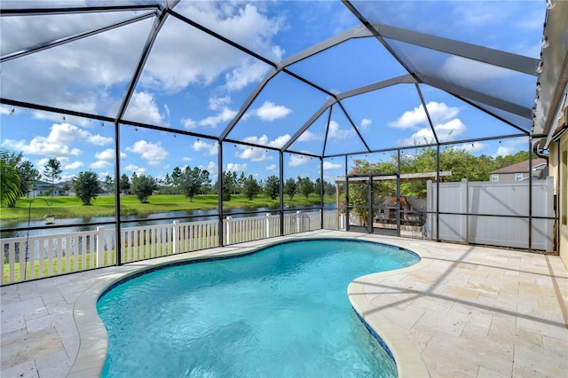 view of pool with a patio, a water view, and a lanai