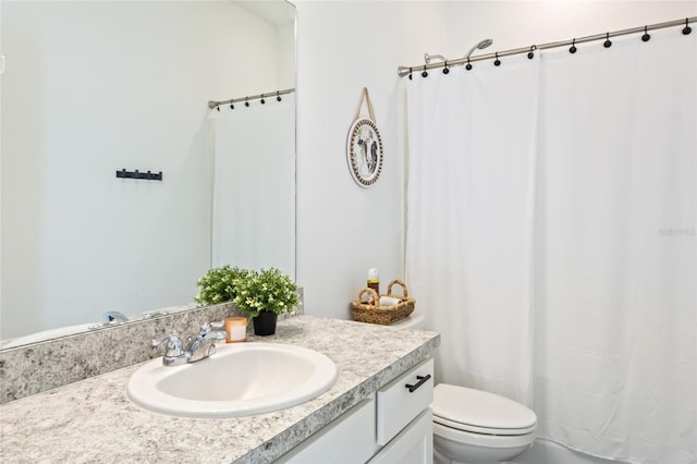 bathroom with walk in shower, vanity, and toilet