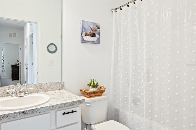 bathroom with vanity and toilet