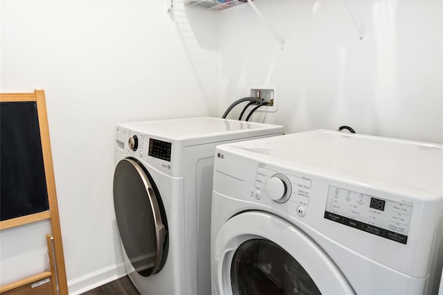 washroom with dark hardwood / wood-style floors and washing machine and clothes dryer