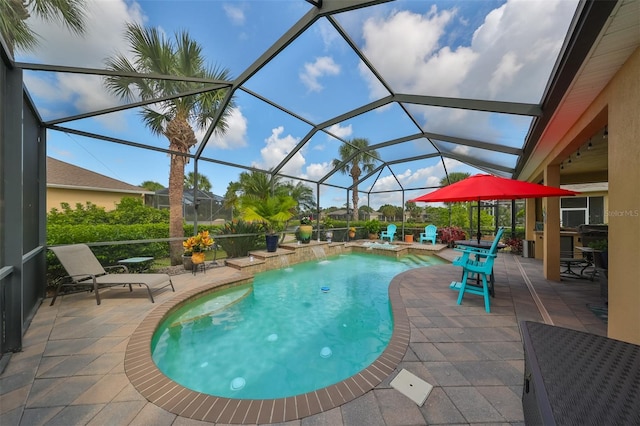 view of swimming pool featuring a patio area, pool water feature, and glass enclosure