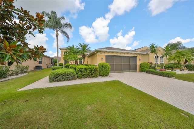 view of front of property with cooling unit, a front lawn, and a garage