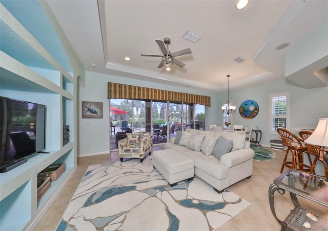 living room featuring a tray ceiling, light tile patterned floors, and ceiling fan with notable chandelier