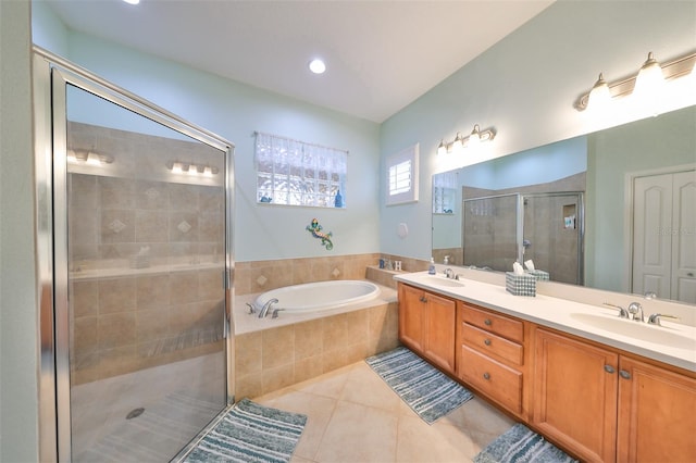 bathroom with tile patterned floors, vanity, and independent shower and bath