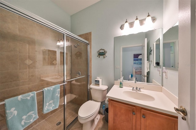 bathroom with vanity, toilet, and a shower with shower door