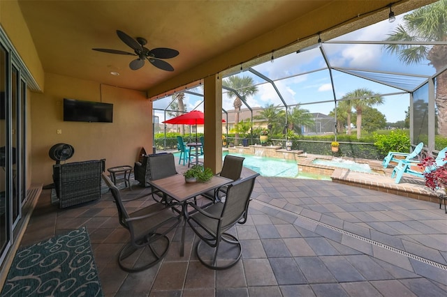 view of patio / terrace with pool water feature, ceiling fan, a lanai, and a pool with hot tub