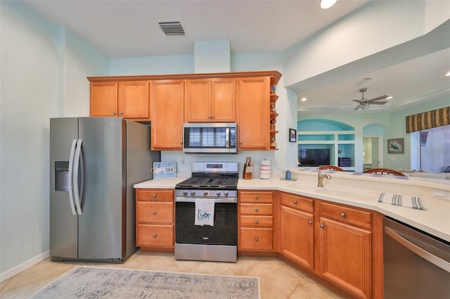 kitchen featuring ceiling fan, light tile patterned floors, sink, and appliances with stainless steel finishes