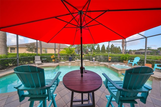 view of swimming pool featuring an in ground hot tub, pool water feature, glass enclosure, and a patio area