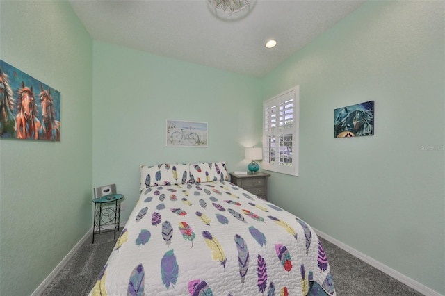 bedroom featuring dark colored carpet and vaulted ceiling