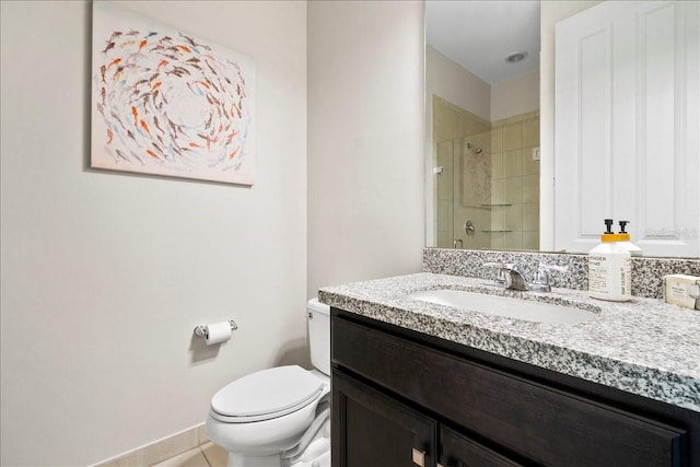 bathroom featuring toilet, a shower with door, vanity, and tile patterned flooring