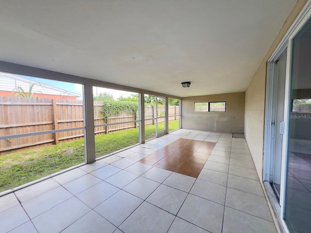 unfurnished sunroom featuring vaulted ceiling