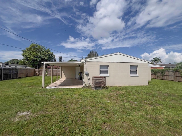 rear view of house with a lawn, a patio area, and central air condition unit