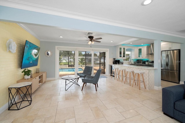 dining room featuring ornamental molding, ceiling fan, and brick wall