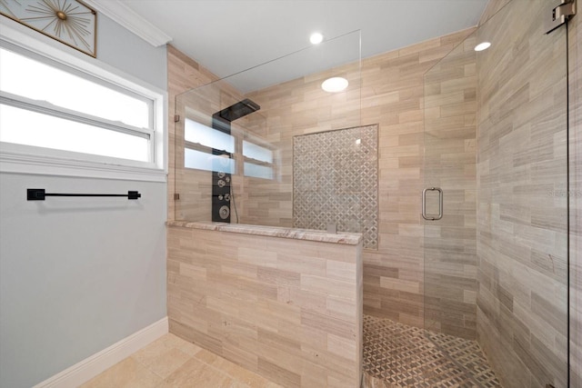 bathroom with tile patterned floors, a shower with shower door, and crown molding