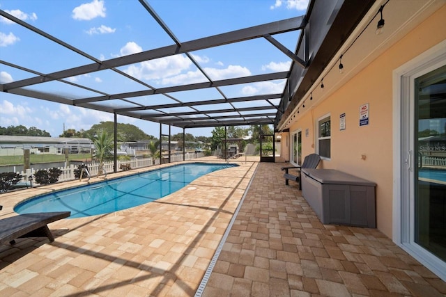 view of swimming pool featuring a lanai and a patio area