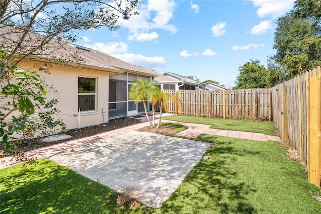 view of yard with a patio area and a sunroom