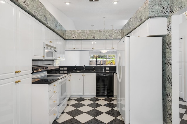 kitchen featuring white appliances, white cabinetry, and sink