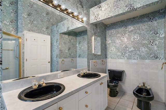 bathroom with walk in shower, vanity, a bidet, tile patterned flooring, and toilet