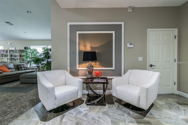 sitting room featuring a textured ceiling