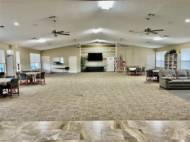 living room with light colored carpet, a textured ceiling, and vaulted ceiling