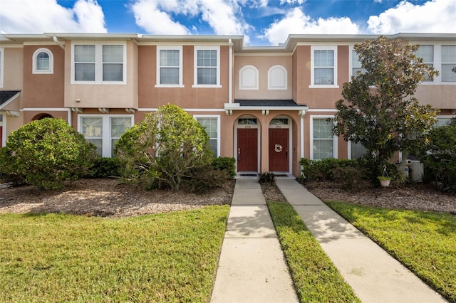 6950 Towering Spruce Dr, Riverview, FL 33578 - townhome / multi-family property featuring stucco siding and a front yard