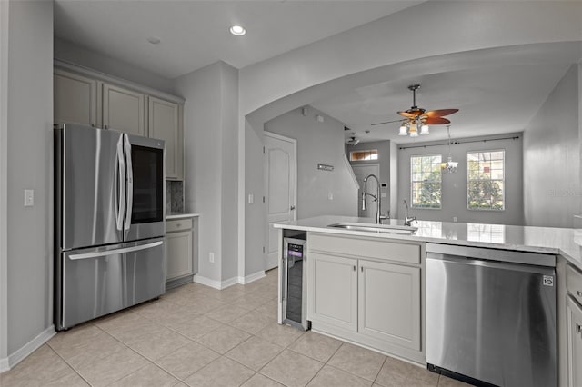 kitchen with wine cooler, light tile patterned floors, stainless steel appliances, ceiling fan, and sink