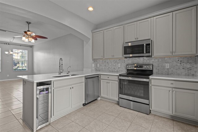 6950 Towering Spruce Dr, Riverview, FL 33578 - kitchen featuring stainless steel appliances, wine cooler, light countertops, a sink, and a peninsula