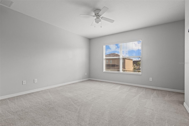 empty room featuring ceiling fan and carpet