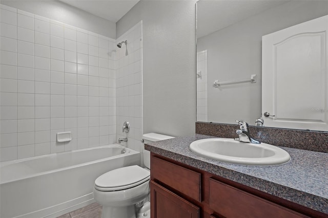 full bathroom with tiled shower / bath, vanity, tile patterned flooring, and toilet