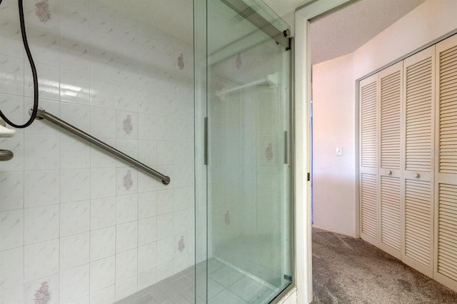 bathroom with a shower with door