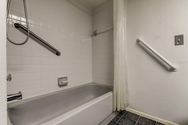 bathroom with shower / bath combination with curtain