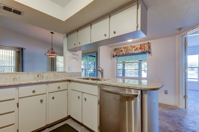 kitchen featuring stainless steel dishwasher, white cabinets, kitchen peninsula, and hanging light fixtures