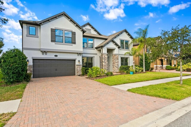 craftsman inspired home featuring a front yard and a garage