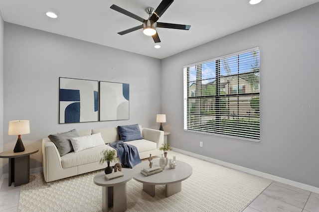living room featuring baseboards, ceiling fan, tile patterned flooring, and recessed lighting