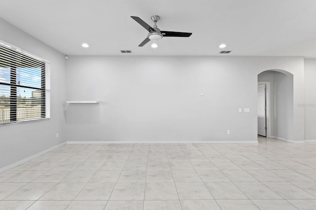 unfurnished room featuring recessed lighting, arched walkways, ceiling fan, and visible vents