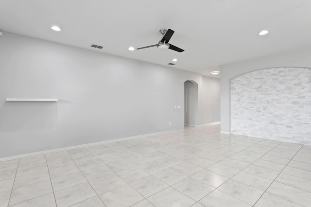 empty room with recessed lighting, baseboards, arched walkways, visible vents, and a ceiling fan