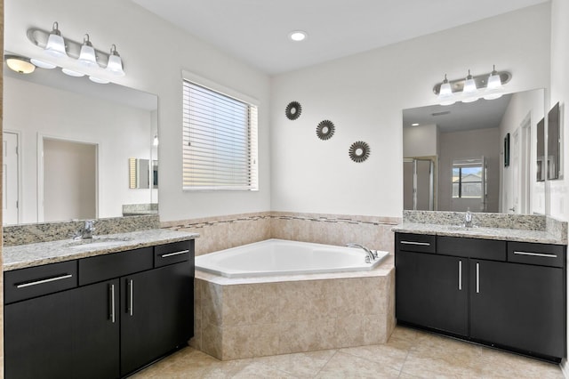 bathroom with tile patterned floors, vanity, and separate shower and tub