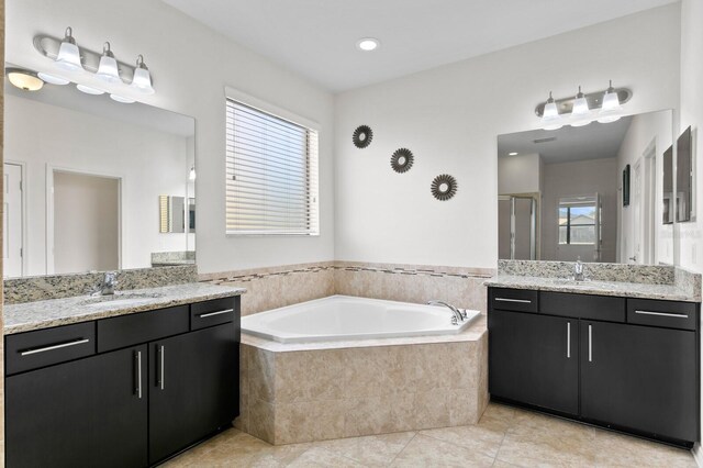 full bathroom featuring a sink, a garden tub, a shower stall, tile patterned flooring, and plenty of natural light