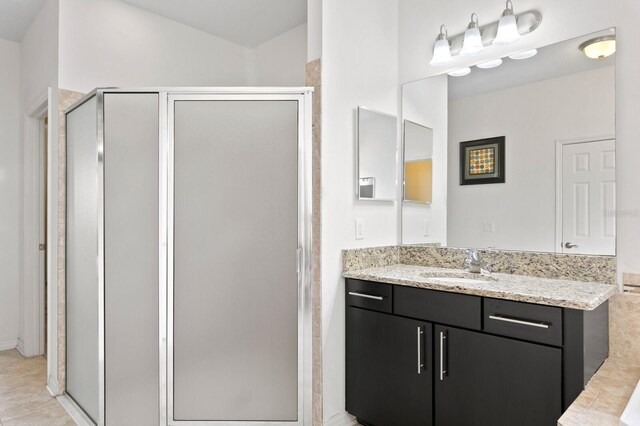 bathroom featuring vanity and a stall shower