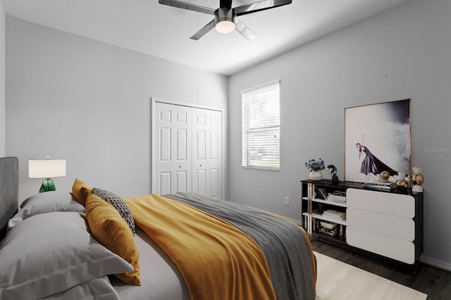 bedroom with a closet, wood finished floors, and a ceiling fan