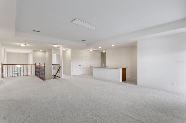 spare room featuring recessed lighting, light colored carpet, and visible vents